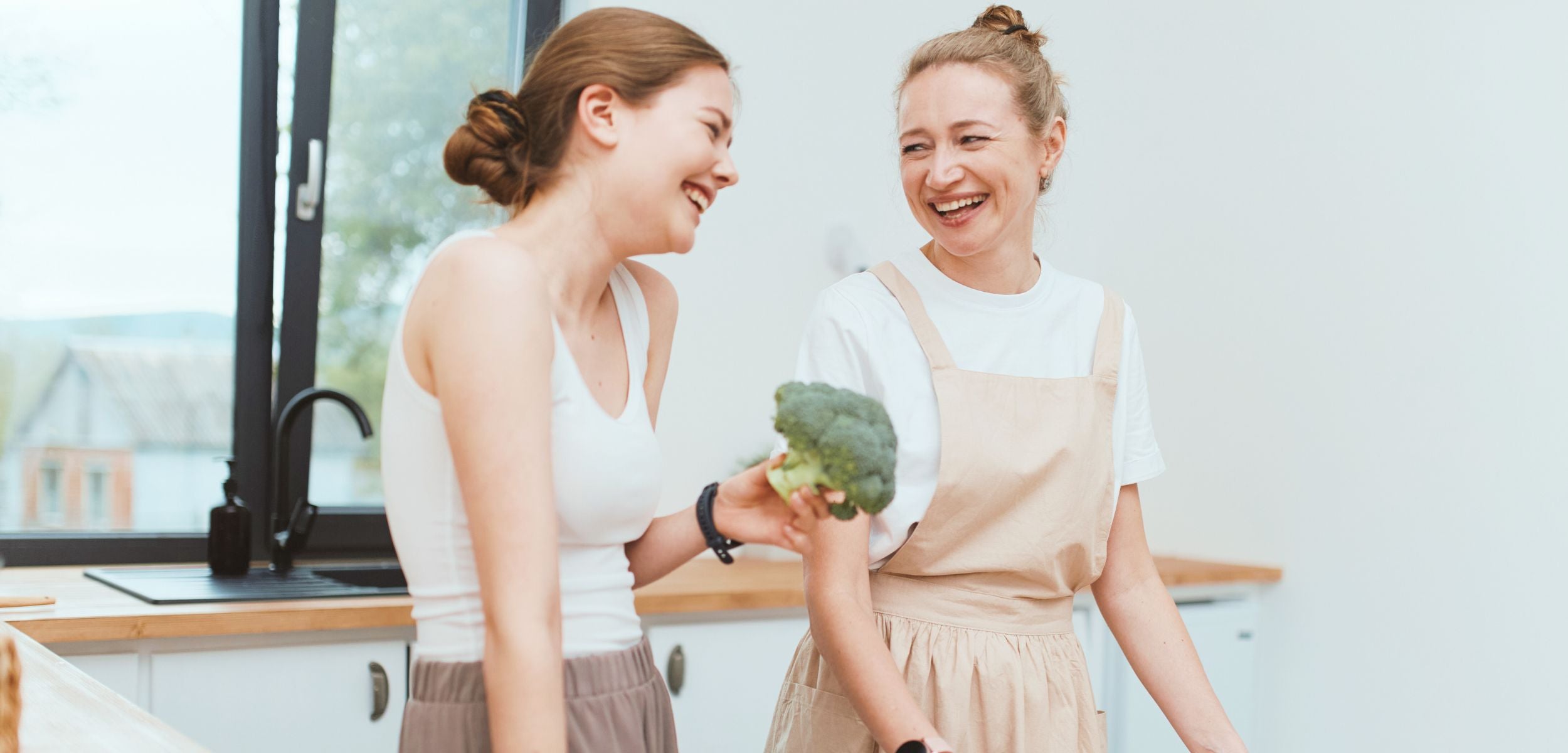 Two women preparing food together representing Axis BioLabs’ fair value and everyday wellness philosophy.