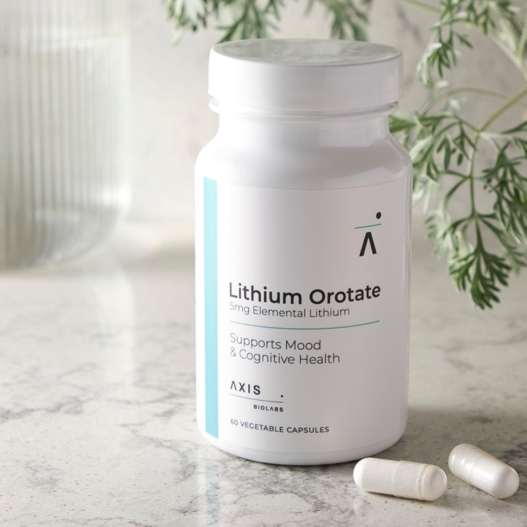 Bottle of Axis BioLabs Lithium Orotate supplement with capsules on a marble surface